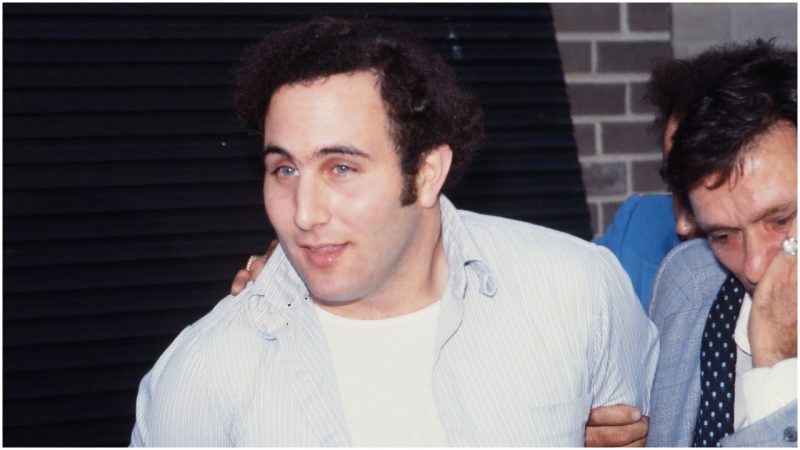 Police officers escort American accused (and ultimately convicted) serial killer David Berkowitz (left), known as the Son of Sam, into the 84th precinct station, New York, New York, August 10, 1977. (Photo by Robert R. McElroy/Getty Images)
