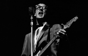 Buddy Holly, performs on stage, playing Fender Stratocaster guitar, 25 March 1958.