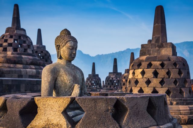 Ancient Buddha statue and stupa at Borobudur temple in Yogyakarta, Java, Indonesia.