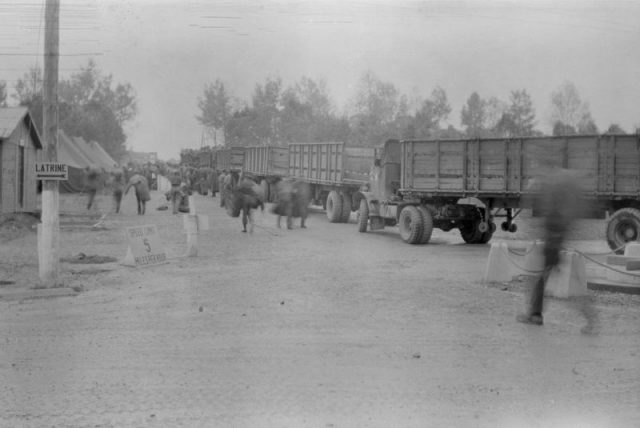 Image of soldiers and trucks arriving into one of The Cigarette Camps. Photo Credit: Rescued Film Project
