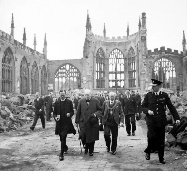 Winston Churchill walks through the ruins of Coventry Cathedral with Alfred Robert Grindlay, 1941