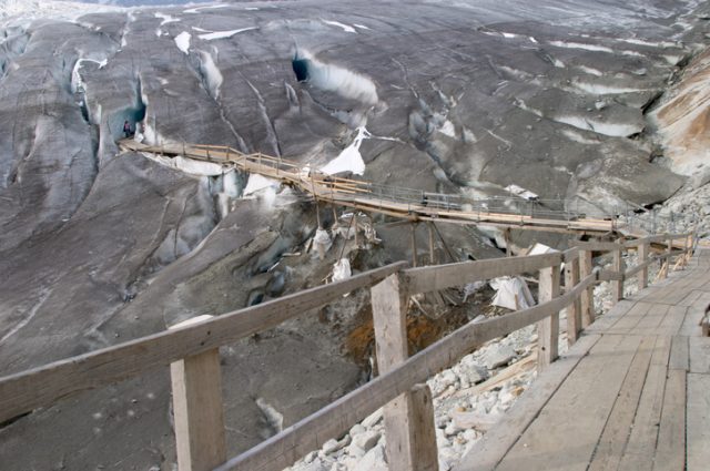 Entrance and footbridge of the ice cave (Eisgrotte am Rhonegletscher) on Furka Pass, Alps, Valais, Switzerland