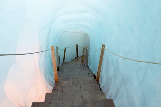 Footbridge inside the ice cave (Eisgrotte am Rhonegletscher) on Furka Pass, Alps, Valais, Switzerland
