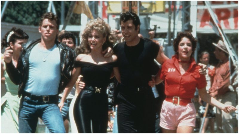  Jeff Conaway, Olivia Newton-John, John Travolta and Stockard Channing walk arm in arm at a carnival in a still from the film, 'Grease' directed by Randal Kleiser. (Photo by Paramount Pictures/Fotos International/Getty Images)