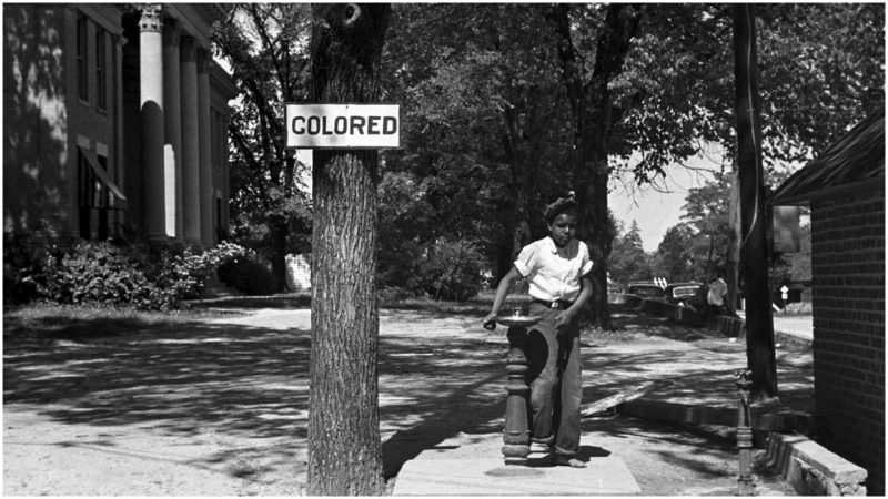 An African-American boy at a segregated drinking fountain in Halifax, North Carolina,