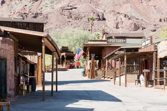 Calico, United States – June 3, 2014: View at some houses on the main street in the Calico ghost town in the desert of California very close to Nevada. Calico is an old west mining touristic village that has been around since 1881. Image taken during daytime.