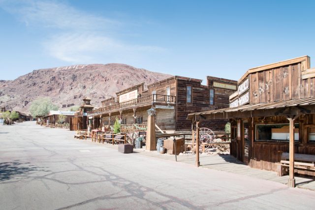 Calico, United States – June 3, 2014: View at the main street in the Calico ghost town in the desert of California very close to Nevada. Calico is an old west mining touristic village that has been around since 1881. Image taken during daytime.