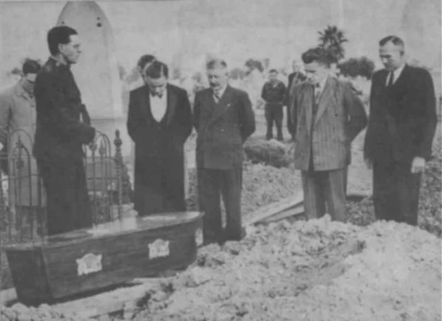 Burial of the Somerton Man on 14 June 1949. By his grave site is Salvation Army Captain Em Webb, leading the prayers, attended by reporters and police.