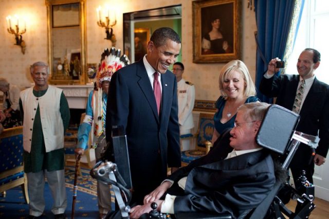 U.S. President Barack Obama talks with Stephen Hawking in the Blue Room of the White House before a ceremony presenting him and 15 others with the Presidential Medal of Freedom on 12 August 2009