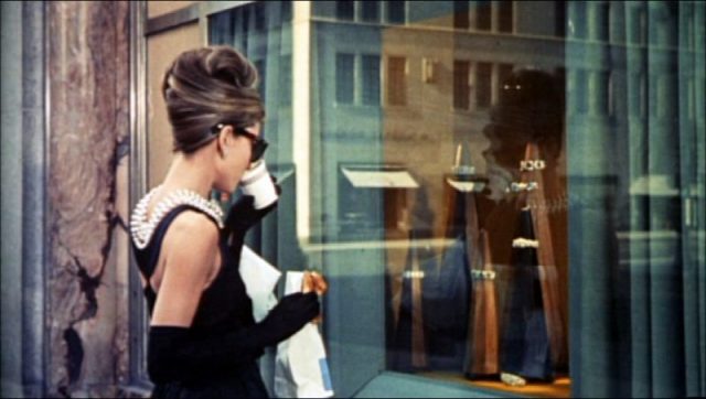 Hepburn in the opening scene of Breakfast at Tiffany’s (1961), wearing the iconic little black dress by Givenchy and the Roger Scemama necklace