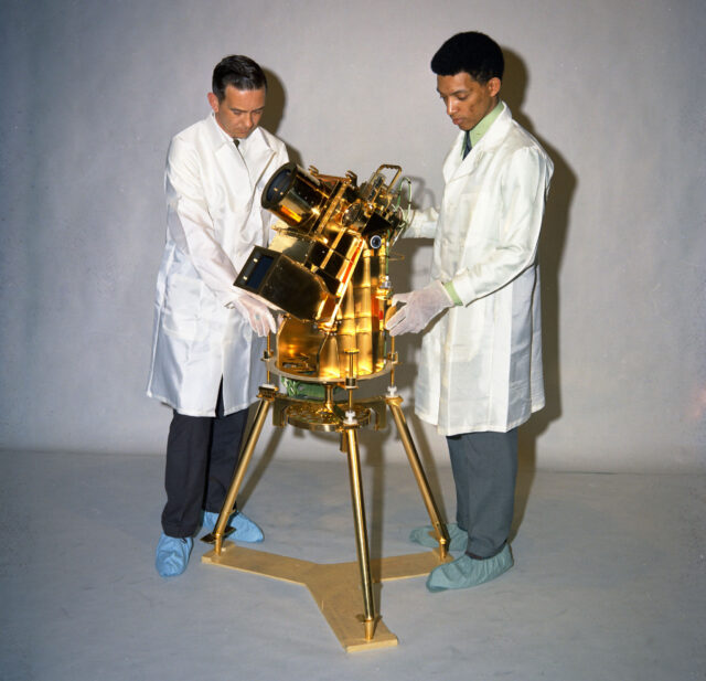 Two men observe the Dr. George Carruthers telescope.