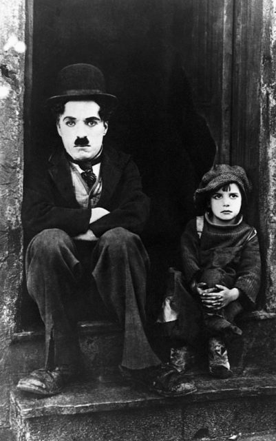 Charlie Chaplin sitting next to young Jackie Coogan