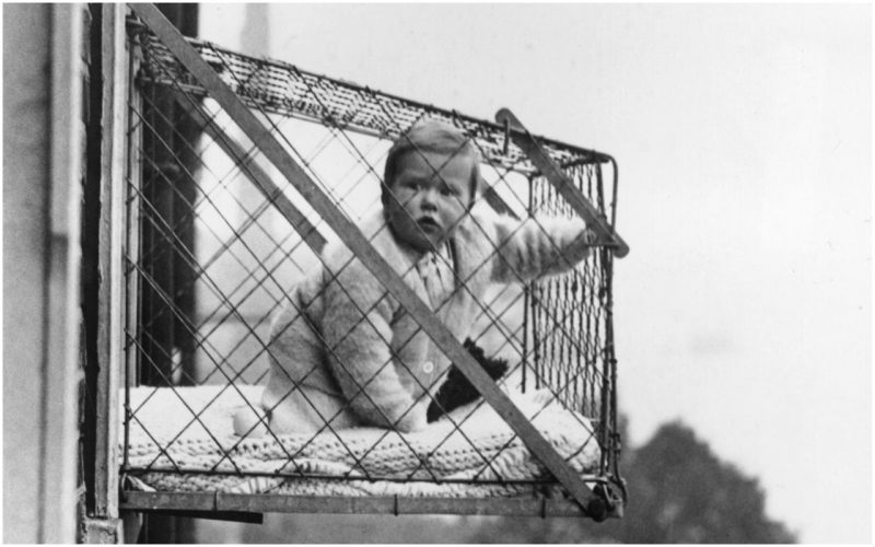 27th January 1934: An example of the wire cage which East Poplar borough council in London propose to fix to the outside of their tenement windows, so that babies can benefit from fresh air and sunshine. (Photo by Fox Photos/Getty Images)