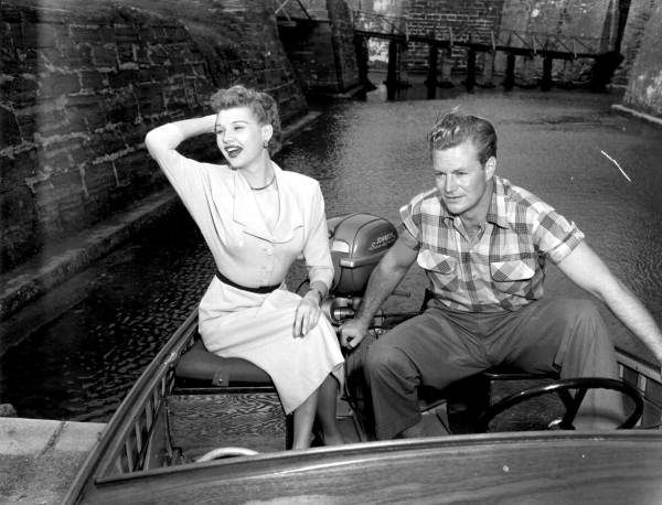 Mari Aldon and Richard Webb sit on a motorboat when visiting the castle during “Distant Drums”