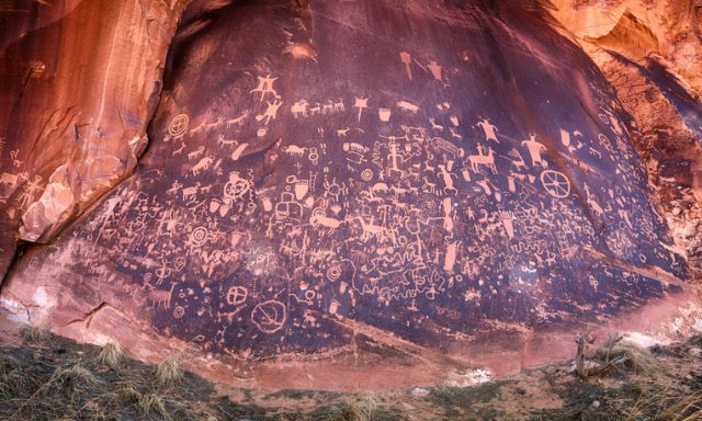 Newspaper rock is a protected wall with ancient Anasazi Indian petroglyphs