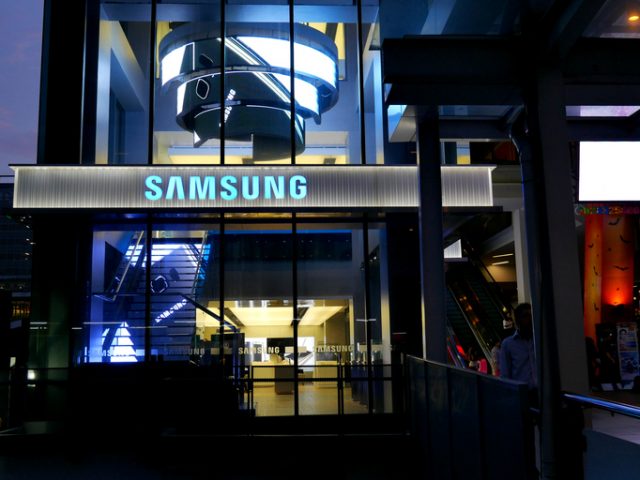 Bangkok, Thailand – November 10, 2015: Exterior view of a Samsung shop in the Siam Square area of Bangkok, Thailand. People walk around the area. The picture is taken from the walkway of sky train station.