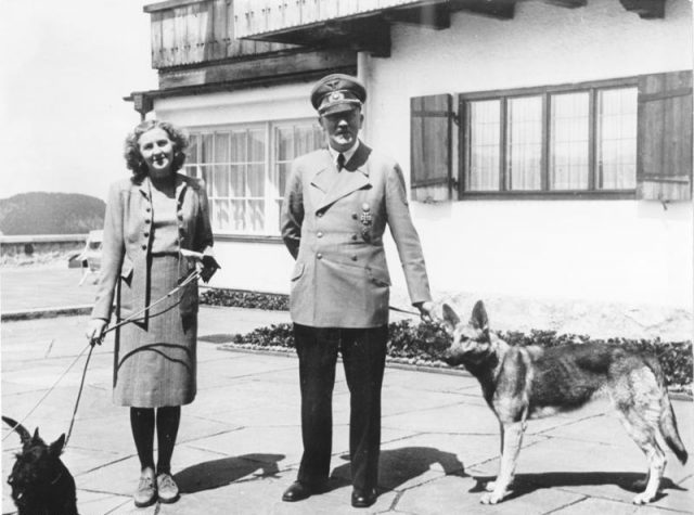 Braun and Hitler with their dogs, June 1942. Photo by Bundesarchiv, B 145 Bild-F051673-0059 / CC-BY-SA
