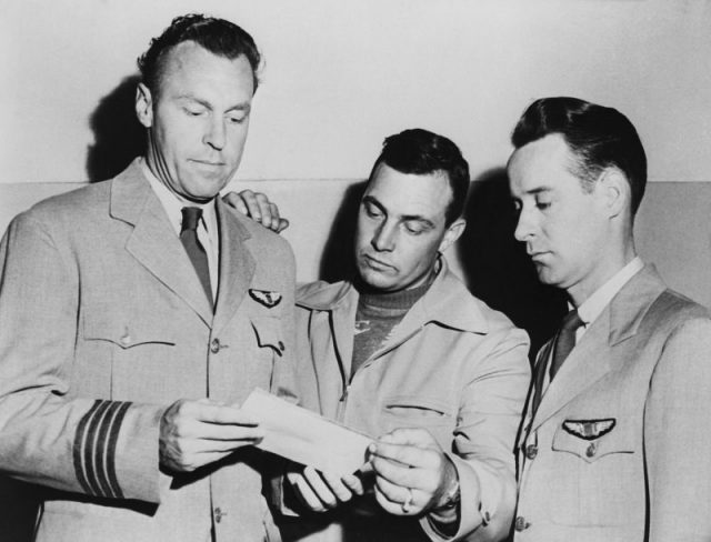 Pilots E. J. Smith, Kenneth Arnold, and Ralph E. Stevens look at a photo of an unidentified flying object which they sighted while en route to Seattle, Washington. Getty images.