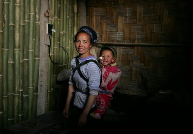 A villager and her son pose in the MIddle Cave, home to a community Photo by Cancan Chu/Getty Images)