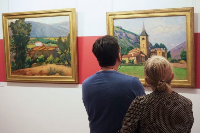 FRANCE-CULTURE-PAINTINGS-INVESTIGATION-COUNTERFEITINGVisitors look at the painting ‘Le clocher de Ria’ (The bell tower of Ria) at the museum dedicated to French painter Etienne Terrus, in Elne (Elna), on April 28, 2018. – Sad inauguration on April 27, 2018 for the museum dedicated to Etienne Terrus, in Elne, in the Pyrenees-Orientales, which saw its collection amputated by 60%, 82 paintings on 140 were counterfeit. (Photo by RAYMOND ROIG / AFP Getty Images)