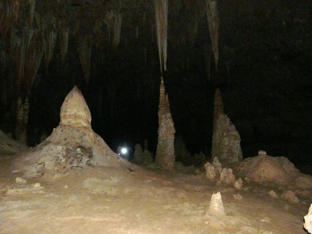 Halah Cave (كهف حالة) in the east of the island is several hundred metres deep, with total darkness. Stalagmites and stalactites show how high it can reach compared to the 1.7 metres (5.6 ft) man with the torch.