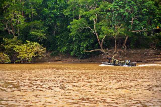 La Macarena, Colombia – October 2, 2010: The Colombian military patrols the Guayabero River near La Macarena on October 2, 2010