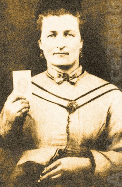 Sarah Malinda Pritchard Blalock. She’s holding the picture of her husband, Keith.