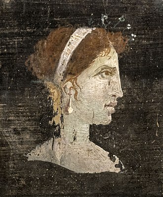 Most likely a posthumous portrait of Cleopatra VII of Ptolemaic Egypt with red hair and her distinct facial features, wearing a royal diadem and pearl-studded hairpins, from Roman Herculaneum, Italy, 1st century AD.