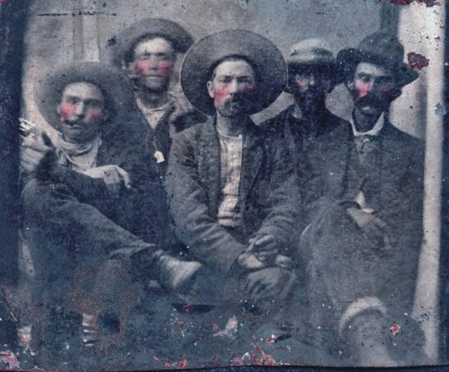 Unauthenticated greyscale group photo allegedly of Billy the Kid and Pat Garrett with three other men.