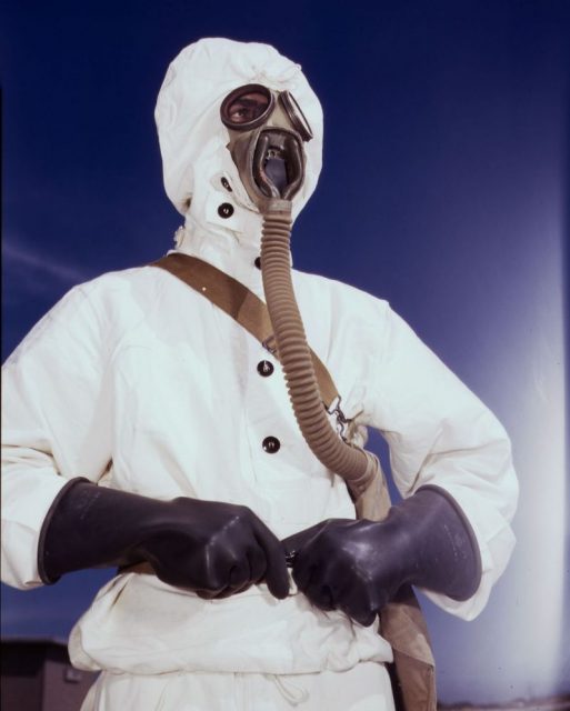 A sailor dressed in brand-new protective clothing with a gas mask to be used in case of a chemical weapon attack.