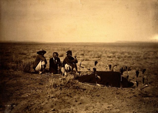 A photograph of Navajo medicine men overseeing a sweat during a Yeibichai ceremony, published in Volume I of The North American Indian (1907) by Edward S. Curtis.