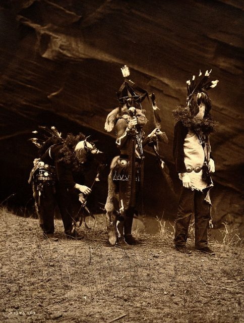 Yebichai War Gods. Photograph by Edward S. Curtis, 1904, shows three Natives – Tonenili, Tobadzischini, and Nayenezgani – in ceremonial dress.