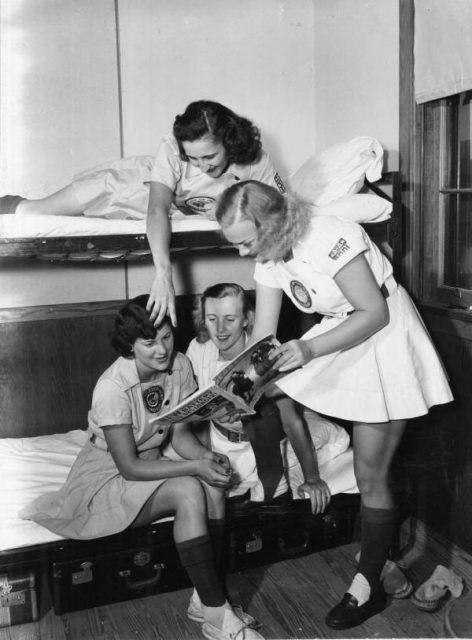 All-American Girls Professional Baseball League members looking at a magazine, Opa-locka, Florida.