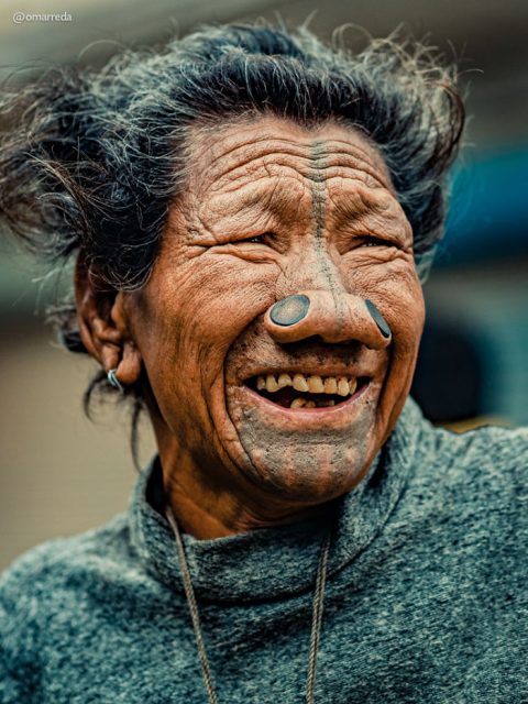 The Apatani women do have beautiful smiles. Their nose plugs and top-down facial tattoos are the last relics of an era that is now long gone. Photo by Omar Reda