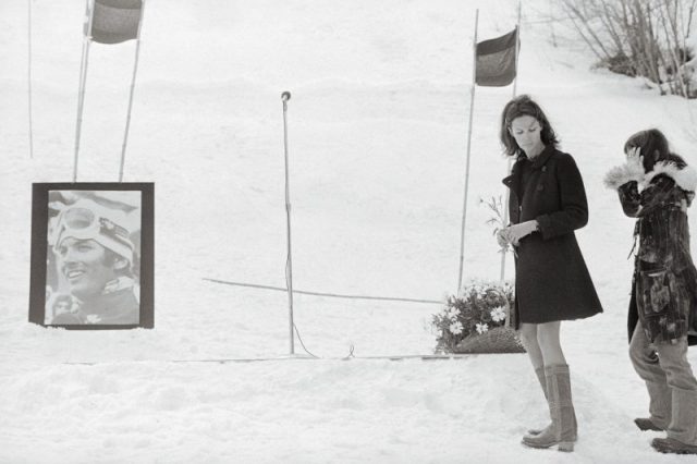 Claudine Longet holding a flower