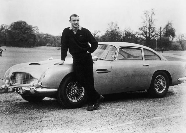 Actor Sean Connery, the original James Bond, is pictured here on the set of Goldfinger with one of the fictional spy’s cars, a 1964 Aston Martin DB5. Photo by Getty Images