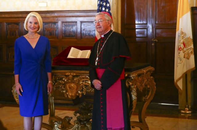 US ambassador to the Holy See Callista L. Gingrich and Archibishop Jean-Luis Brugues pose in front of a copy of a letter written by Christopher Columbus that had been stolen from Vatican archives and returned by the United States to the Vatican Library, during a ceremony at the Vatican on June 14, 2018. (Photo by TONY GENTILE / POOL / AFP/Getty)