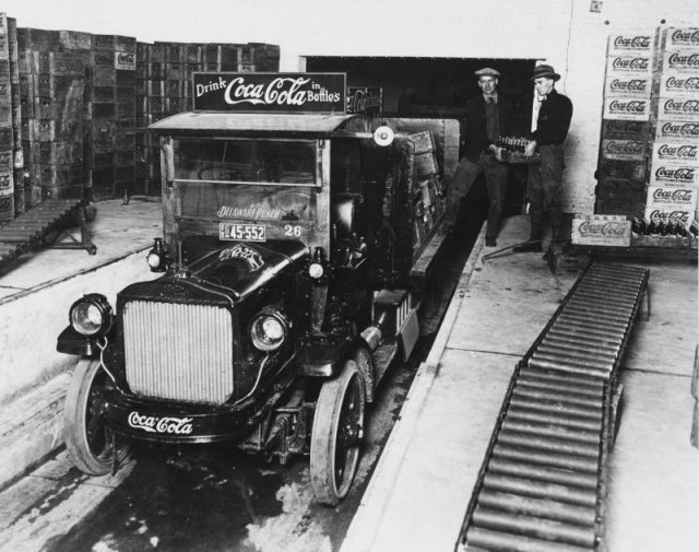 Workers loading crates of Coca-Cola bottles onto a truck at the plant, c.1930. (Photo by American Stock Archive/Archive Photos/Getty Images)