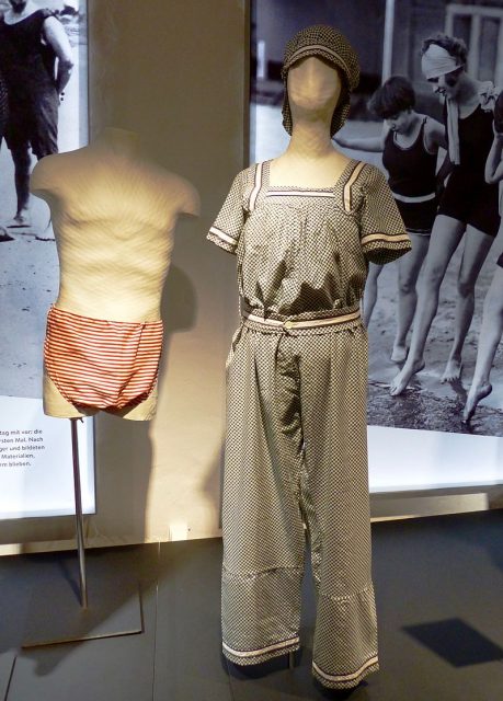 Cotton swimsuit with a button-down skirt. This piece of fashion trended in the period from 1890 to 1910. GLAM-on-Tour: Industrial Museum Cromford Textile Factory in Ratingen 2016. Photo by Geolina163 CC BY-SA 4.0
