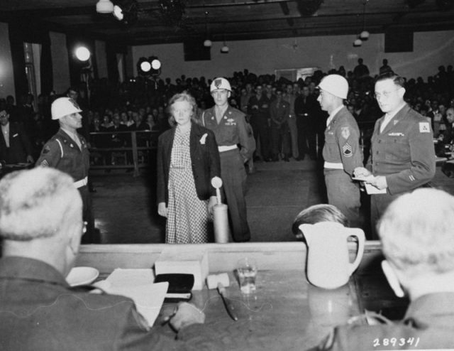 Ilse Koch is sentenced to life in prison by Brigadier General Emil C. Kiel (back to camera) at the trial of former camp personnel and prisoners from Buchenwald.