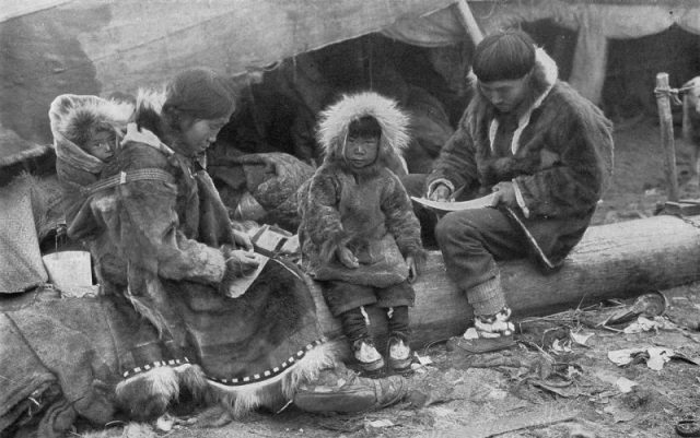 Inuit family here photographed in 1917. The child is very cosy, strapped to its mother’s back.