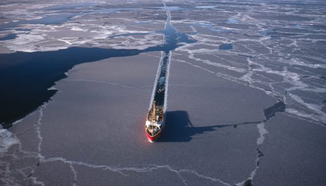 An ice breaker makes a path in the Arctic Sea