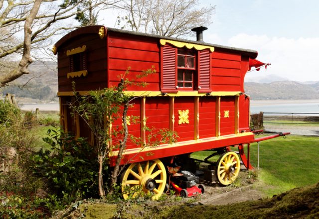 A colorful Romani caravan overlooking the Mawddach Estuary in Wales. This one is a Burton wagon – the wheels are underneath the body, allowing more room inside than a Reading or Ledge.