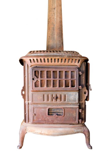 A brown antique wood heat stove.