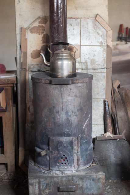 An old wood-box stove. The water will boil any minute now.