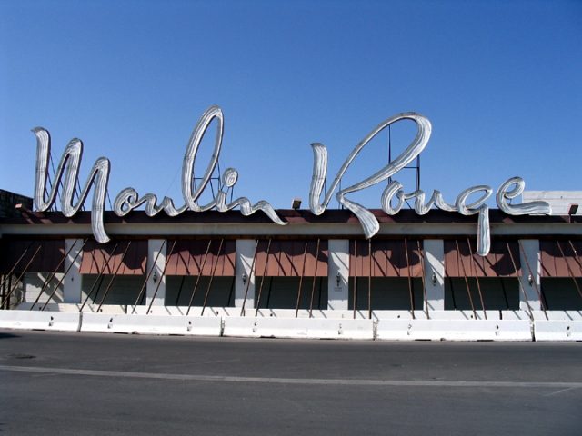 Daytime photograph of the sign of the closed Moulin Rouge hotel & casino. Photo by BentaiCC BY-SA 3.0