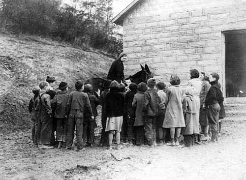 The librarians made regular calls at mountain schools. The little stone school shown here was built by the WPA in Kentucky and replaced an antiquated log building.