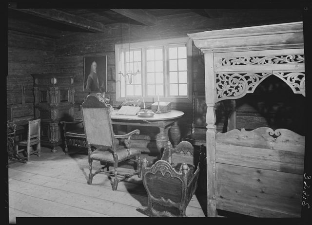 Vintage black and white photo. The all-wood bedroom looks very homely, with a writing desk for ma or pa to use while baby sleeps.