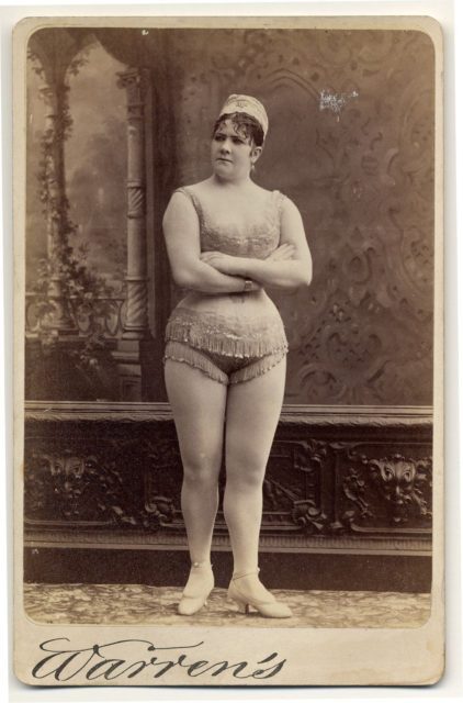 Viola Clifton facing front in a sleeveless, short, fringed top and short, fringed trunks. Photo by Dr. Charles H. McCaghy Collection