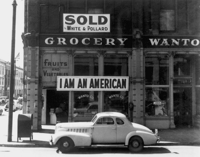 A Japanese American unfurled this banner the day after the Pearl Harbor attack. This Dorothea Lange photograph was taken in March 1942, just prior to the man’s internment.